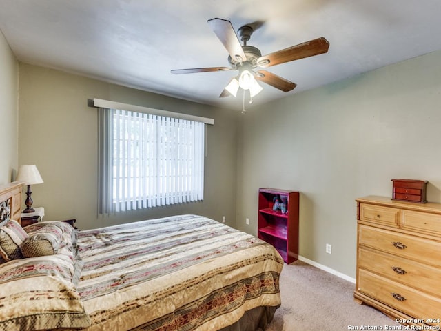 bedroom featuring baseboards, a ceiling fan, and light colored carpet