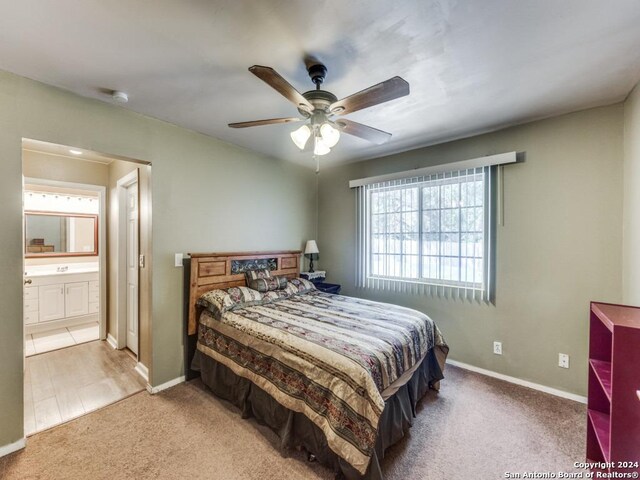 bedroom featuring ceiling fan, connected bathroom, and carpet flooring