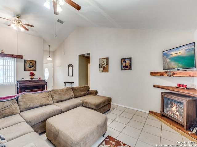 living area featuring light tile patterned floors, visible vents, a ceiling fan, vaulted ceiling, and a fireplace