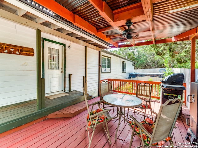 wooden deck with ceiling fan and a grill