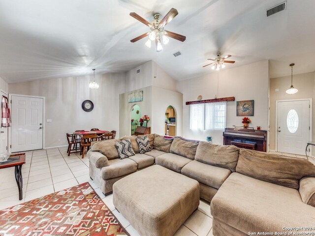 tiled living room featuring ceiling fan and lofted ceiling