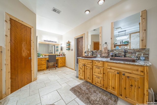 bathroom featuring vanity, decorative backsplash, and tile patterned flooring