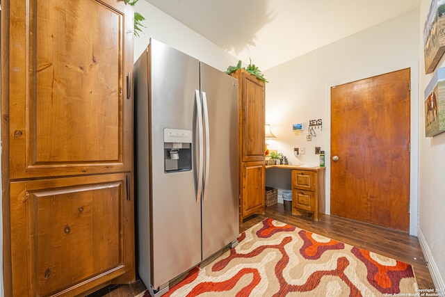 kitchen with stainless steel refrigerator with ice dispenser and dark wood-type flooring