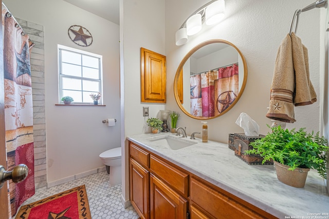 bathroom featuring vanity, toilet, and tile patterned floors