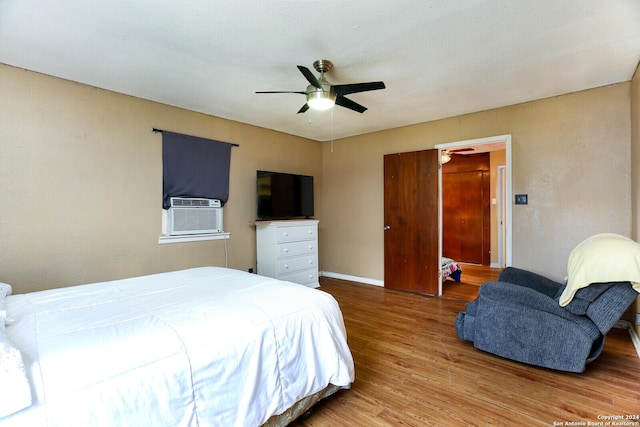 bedroom featuring hardwood / wood-style floors, ceiling fan, and cooling unit