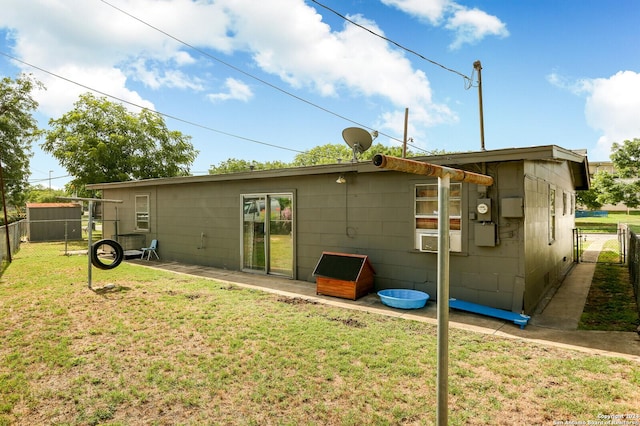 rear view of property featuring a yard