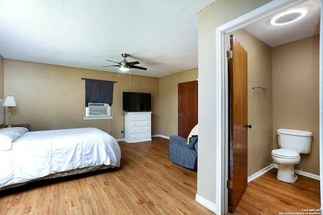 bedroom with wood-type flooring, ceiling fan, and cooling unit