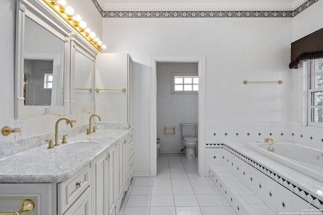 bathroom featuring vanity, tiled tub, tile patterned floors, and toilet