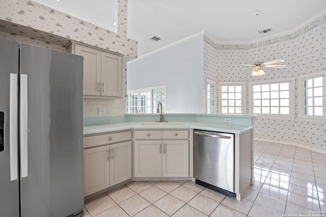 kitchen with sink, ceiling fan, appliances with stainless steel finishes, light tile patterned flooring, and kitchen peninsula