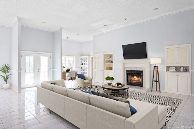 tiled living room with ornamental molding, a tile fireplace, a textured ceiling, and a high ceiling