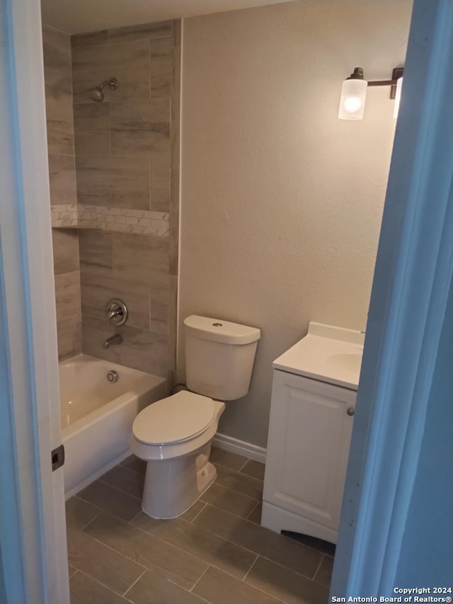 full bathroom with tile patterned floors, toilet, vanity, and tiled shower / bath