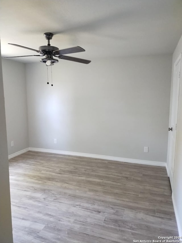 unfurnished room featuring hardwood / wood-style flooring and ceiling fan