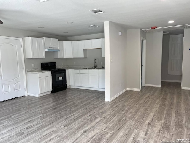 kitchen featuring white cabinetry, sink, light hardwood / wood-style flooring, and electric range