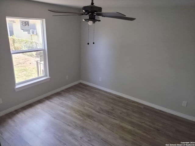 unfurnished room with dark hardwood / wood-style flooring and ceiling fan