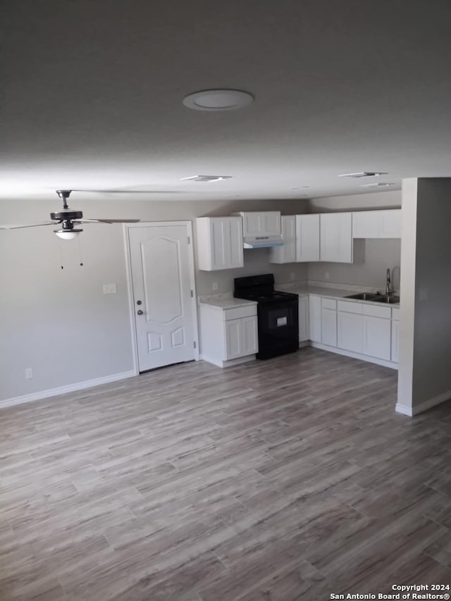 kitchen featuring hardwood / wood-style flooring, sink, black electric range oven, white cabinetry, and ceiling fan