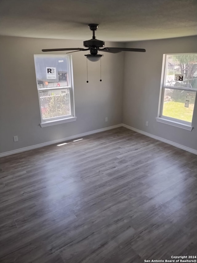 unfurnished room with dark hardwood / wood-style floors and ceiling fan