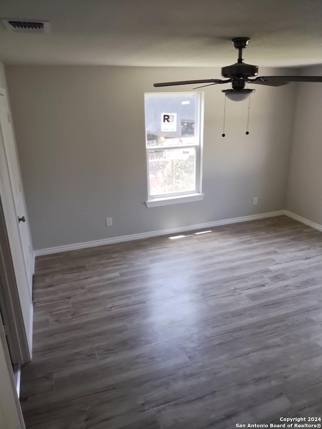 unfurnished room with hardwood / wood-style flooring and ceiling fan