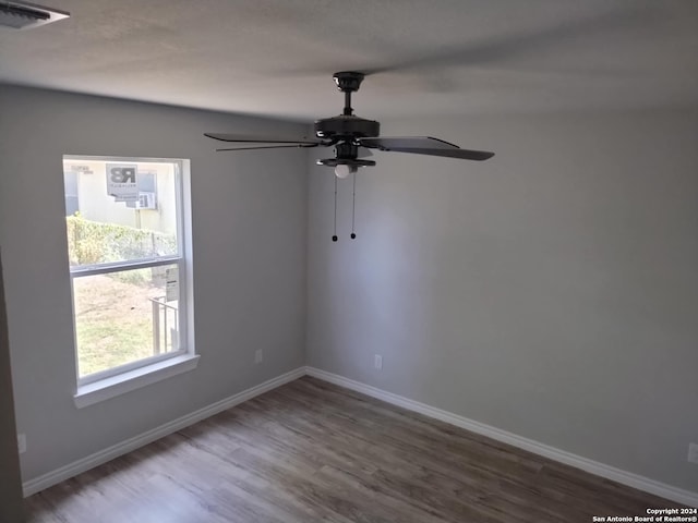 unfurnished room featuring ceiling fan and hardwood / wood-style flooring