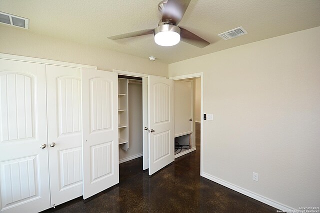 unfurnished bedroom featuring baseboards, visible vents, ceiling fan, and a textured ceiling