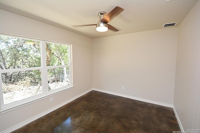 spare room with visible vents, baseboards, and ceiling fan