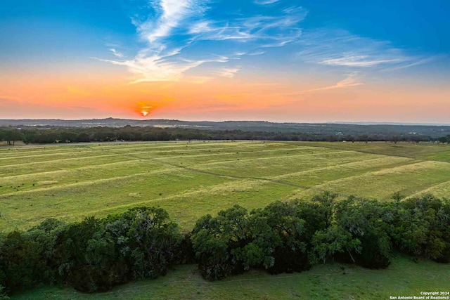 aerial view at dusk featuring a rural view