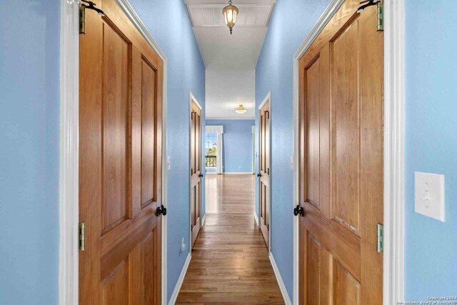 corridor featuring hardwood / wood-style floors