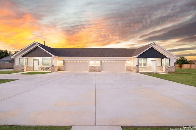 view of front facade featuring a lawn and a garage