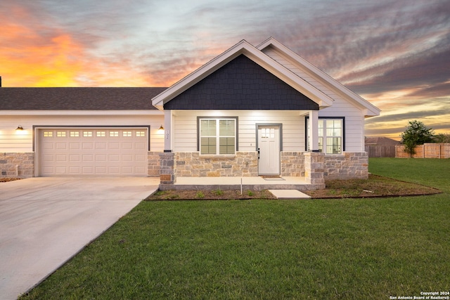 craftsman house featuring a garage and a yard