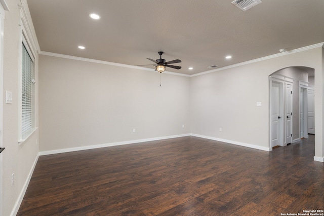 spare room featuring crown molding, ceiling fan, and dark wood-type flooring