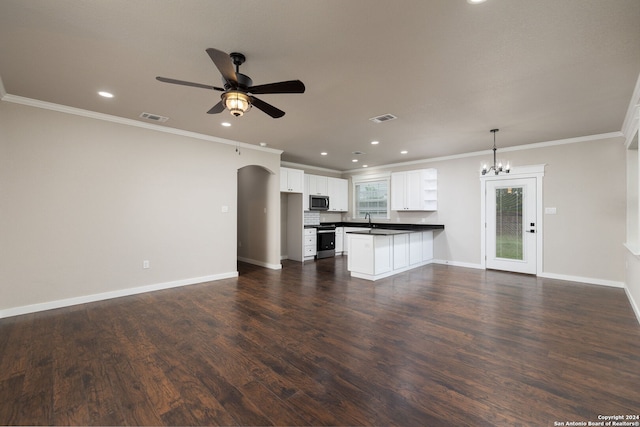 interior space with kitchen peninsula, stainless steel appliances, decorative light fixtures, white cabinets, and dark hardwood / wood-style floors