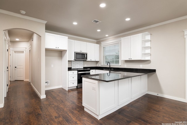 kitchen featuring white cabinetry, dark wood-type flooring, backsplash, kitchen peninsula, and appliances with stainless steel finishes