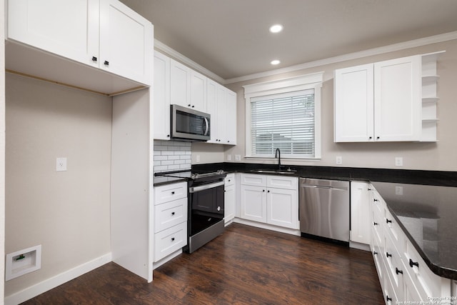 kitchen with backsplash, stainless steel appliances, sink, dark hardwood / wood-style floors, and white cabinetry