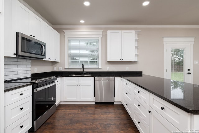 kitchen featuring dark stone countertops, sink, white cabinetry, and stainless steel appliances