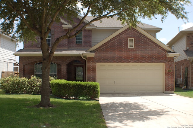 front of property featuring a garage and a front lawn