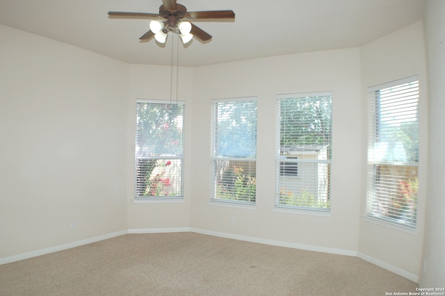 carpeted empty room featuring ceiling fan