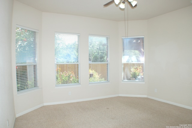 unfurnished room with ceiling fan, carpet flooring, and a healthy amount of sunlight