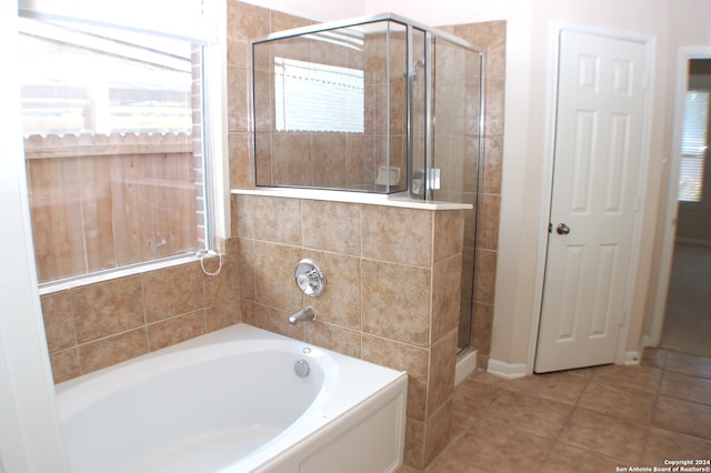 bathroom with tile patterned flooring and independent shower and bath