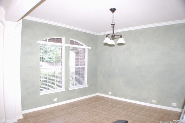 empty room featuring decorative columns, tile patterned flooring, crown molding, and a chandelier