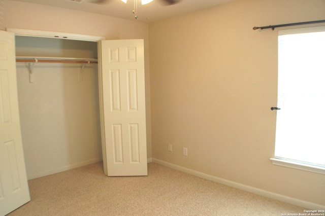 unfurnished bedroom with carpet floors and a closet