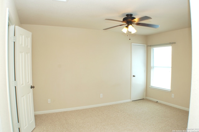 unfurnished room with ceiling fan and carpet flooring