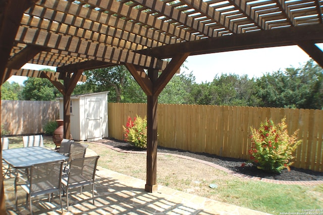 view of patio / terrace with a pergola and a storage unit