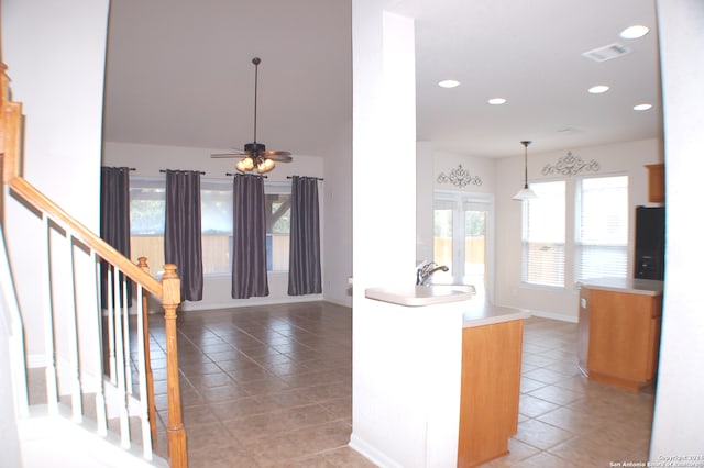 kitchen with sink, pendant lighting, ceiling fan, and tile patterned floors