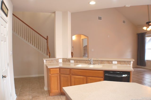 kitchen featuring light tile patterned flooring, ceiling fan, black dishwasher, sink, and high vaulted ceiling