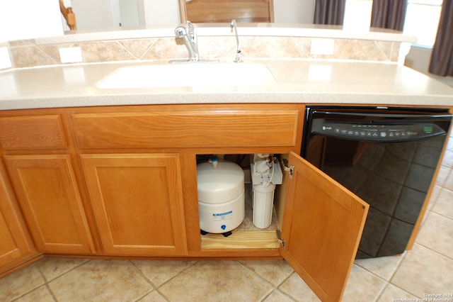 kitchen featuring light tile patterned flooring, sink, and dishwasher