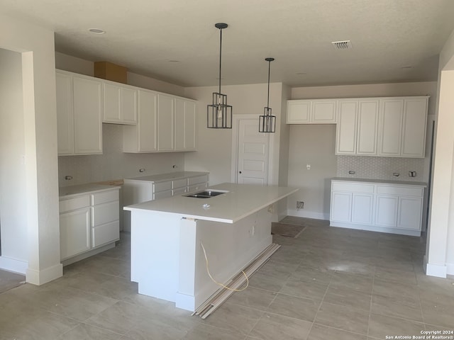 kitchen with a center island, white cabinets, and light tile patterned floors