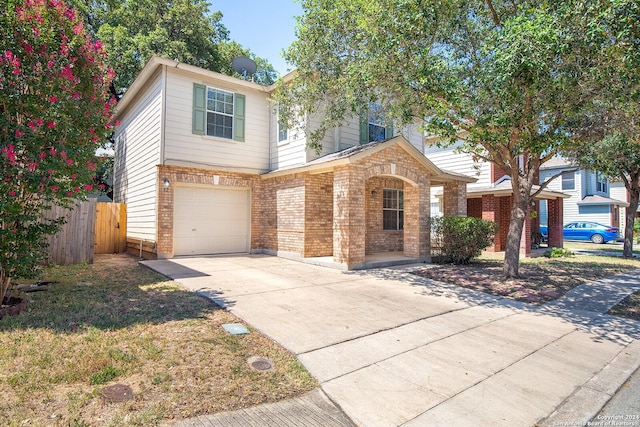 view of front of home featuring brick siding, concrete driveway, an attached garage, and fence