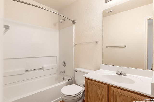 bathroom with visible vents, toilet, vanity, shower / bathtub combination, and a textured wall