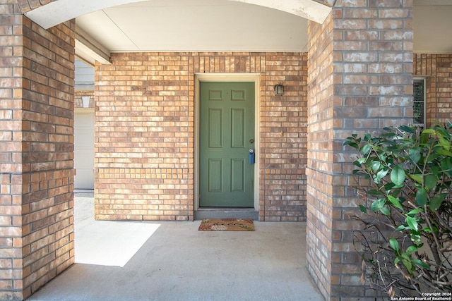 property entrance featuring brick siding