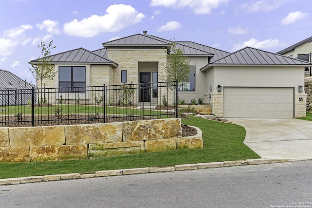 view of front of property featuring a front yard and a garage