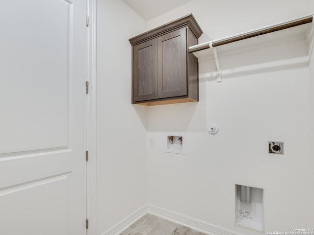 washroom featuring washer hookup, cabinets, gas dryer hookup, and electric dryer hookup